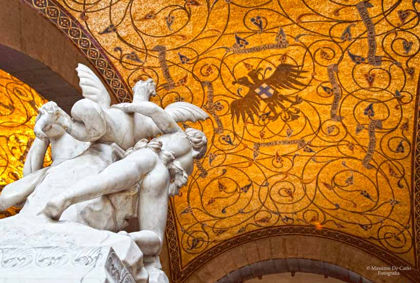 The vaulted, majolica ceiling with a gold background in the Carlo Filangieri hall